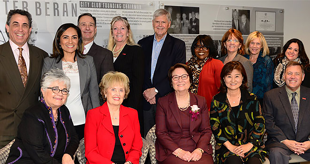 Dean Karen Symms Gallagher (center), accepts an award from City Club Los Angeles, accompanied by members of the USC Rossier community.
