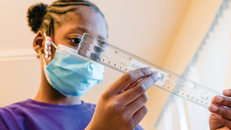 A student studies a ruler