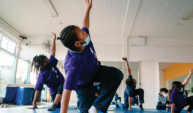Sylinda (left) and Aja (right) participate in a yoga class during after-school programming at the Crenshaw Family YMCA .