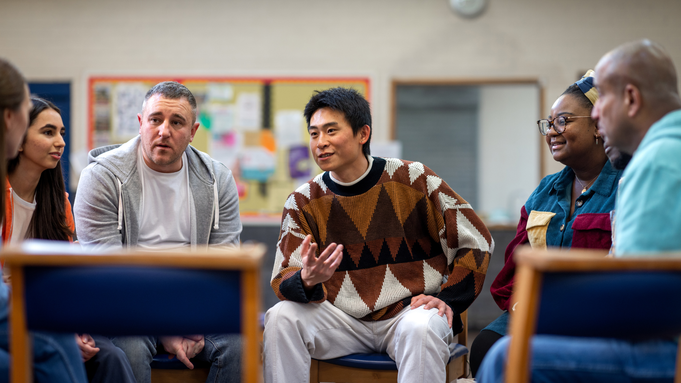 Individuals engaging in group discussion.