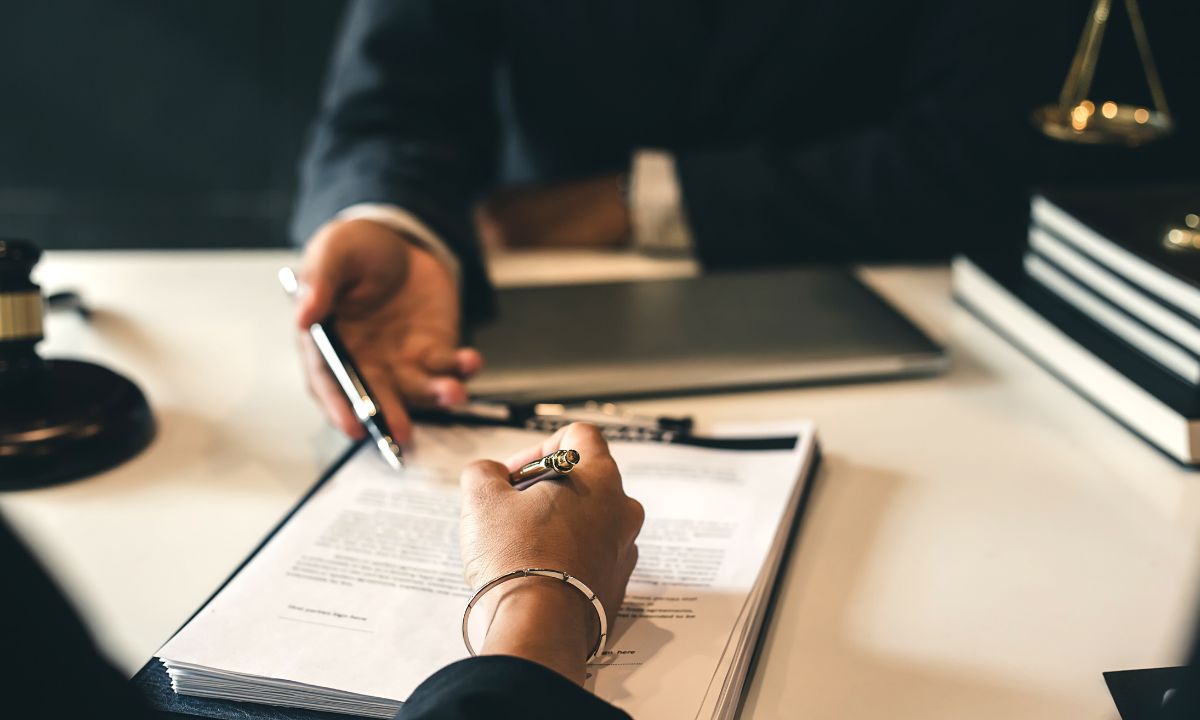 two people looking over a document