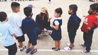 On August 31—the first day of school at Long Beach Unified—Superintendent Jill Baker EdD ’04 asks first graders at Roosevelt Elementary School if they have lost any teeth yet.