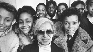 Civil rights icon Rosa Parks with grade school students in 1983 (Courtesy of Getty Images).