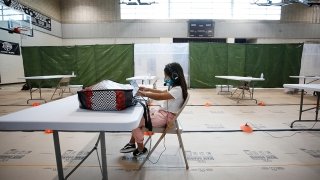 A second grader attends online school from her socially-distanced desk at the Delano Recreation Center, which is a part of the Safer at Parks: Alternative Learning Centers and After School Program in Los Angeles. (Photo/Getty Images, Al Seib)