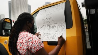 LOS ANGELES, CALIFORNIA - JUNE 23: A demonstrator makes a sign reading 'Invest In The Students Period' as Black Lives Matter-Los Angeles supporters protest outside the Unified School District headquarters calling on the board of education to defund school police on June 23, 2020 in Los Angeles, California. The demonstrators want the funds currently spent on campus police to be reallocated to other student-serving priorities. (Photo by Mario Tama/Getty Images)