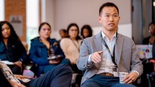 Professor Adam Kho speaks at a welcome summit for new students in USC Rossier’s PhD program.