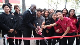 USC Hybrid High School Principal Mac Macauley joins other officials in marking the grand opening of the school's new building, a permanent home in South Los Angeles.