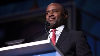 California State Superintendent of Public Instruction Tony Thurmond stands behind a podium during a public address
