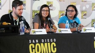 Emily Sandoval smiling and talking on the mic at Comic-Con, encouraging people to embrace their inner geek.
