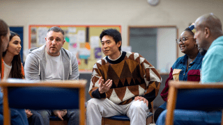 Individuals engaging in group discussion.