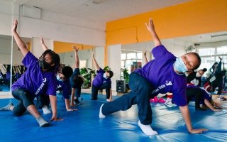 Students at the Crenshaw Family YMCA practice yoga.