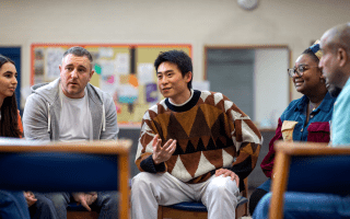 Individuals engaging in group discussion.