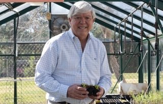 P2020263_hires-640.jpg Knight checks on seedlings in the greenhouse at Oak Hills Elementary School
