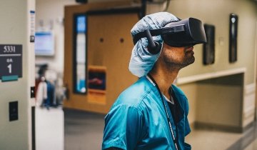 Medical resident watching a quality video featuring a surgical procedure through virtual reality headsets