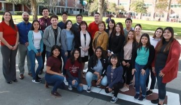 CTBC Executive Vice President Frida Bank Kourouyan (center, with scarf) and Vice President Mona Fontela (center, tan coat) with USC Rossier staff, students and USC CAC advisers at Fremont High School in Los Angeles. PHOTO BY MARGARET MOLLOY