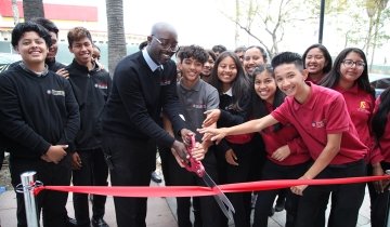 USC Hybrid High School Principal Mac Macauley joins other officials in marking the grand opening of the school's new building, a permanent home in South Los Angeles.