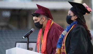 USC-Hybrid-High-salutatorian-Ramon Calvil-reduced.jpg A high school student, dressed in a cap and gown, delivers a speech at graduation.