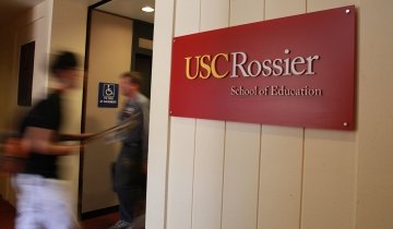 Student walking through USC Rossier's hall