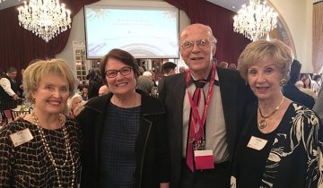 Four senior citizens (3 women and 1 man) enjoying at a luncheon.