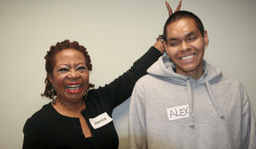 Photo of an adult Black woman and young Black teen.