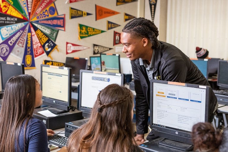 Sayles helps students create logins for college admissions portals and fill out financial aid forms in the Career Center. (Photo/Josh Krause, 211 Photography)