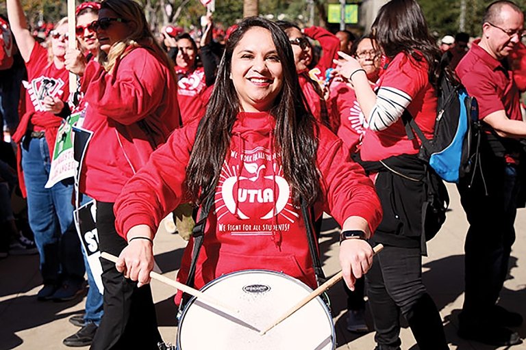 Lizette Bacerra, MAT '18, a teacher in Los Angeles plays a drum during the 2019 UTLA teacher's strike