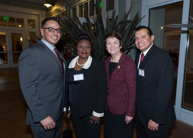 Henry Romero (far left) and fellow scholarship winners Patricia Brent-Sanco (second from left) and Robert Allard (far right) share the moment with Dean Karen Symms Gallagher (third from left). Photo by Benjamin Kaatz.