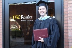 A student wearing a cap and gown at USC Rossier's commencement ceremony.