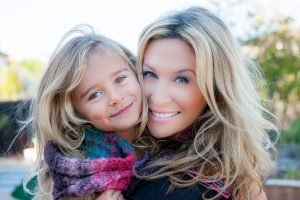 Alum Dustine Rey with her daughter, happy & smiling.