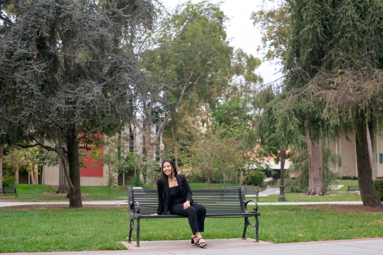 Photo of Ella Rae Bautista Columbres ME ’24 sitting on a bench at the USC UPC campus. 