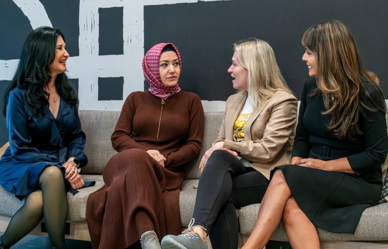 Photo of Yasemine Copur-Gencturk speaking with conference attendees.