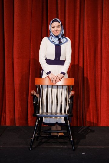 Photo of Yasemin Copur-Gencturk standing behind a chair.