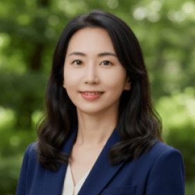 Headshot portrait of Cheyeon Ha smiling in a navy blazer outdoors