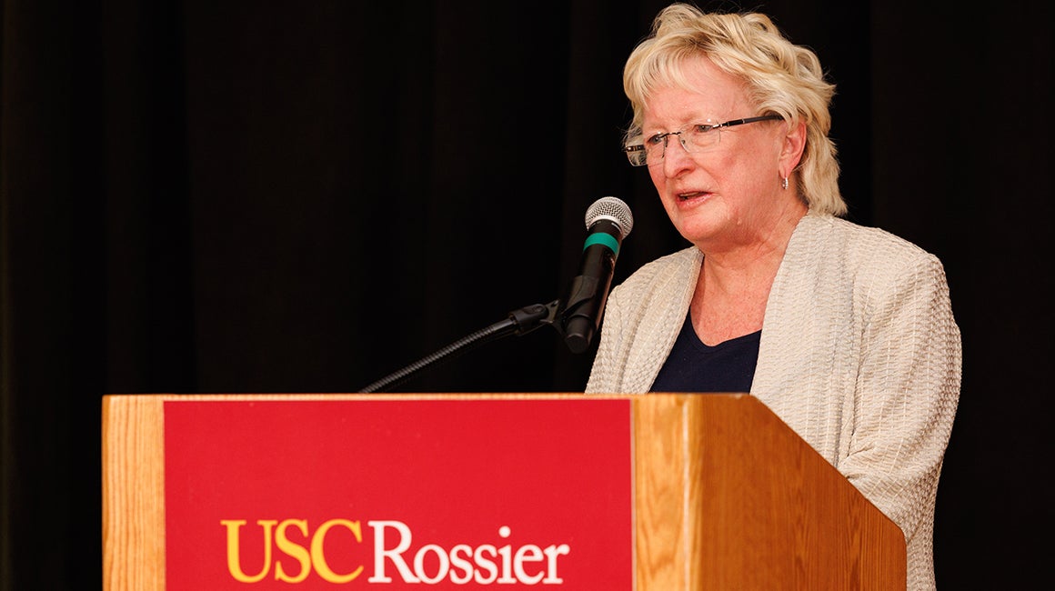 Woman speaking at a USC Rossier DSAG event podium