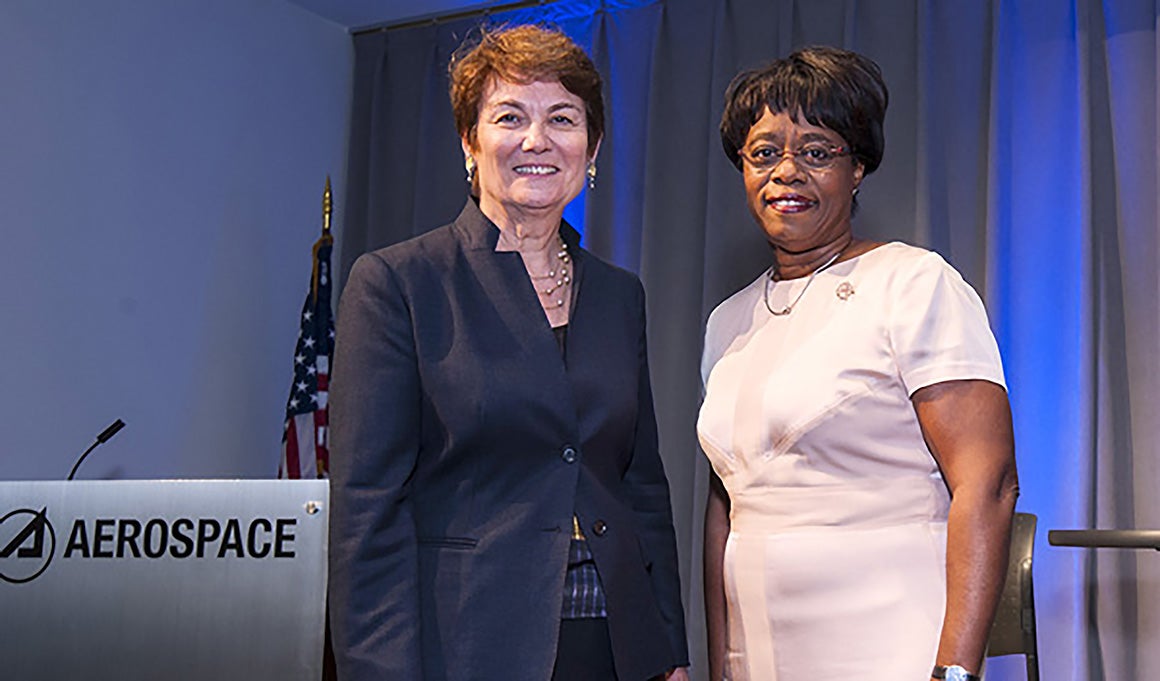 Karen Gallagher standing with a colleague at an aerospace STEM event