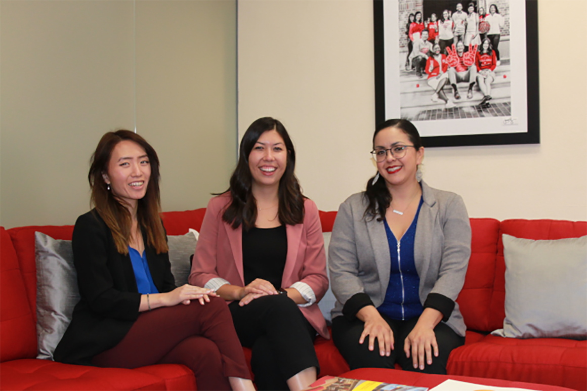 Three colleagues sitting together in an office setting