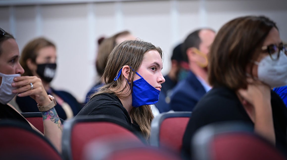 Attendees wearing masks at a school board meeting