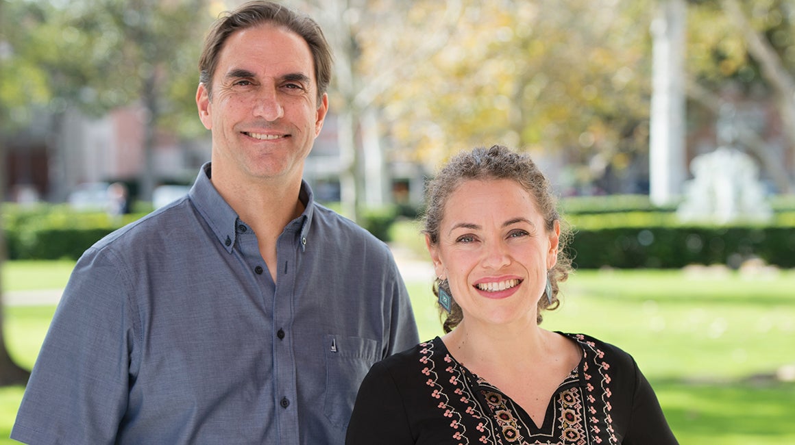 Man and woman standing together outdoors on campus