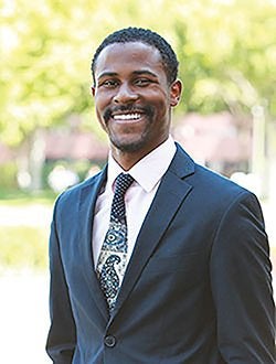Demontea Thompson smiling outdoors on campus