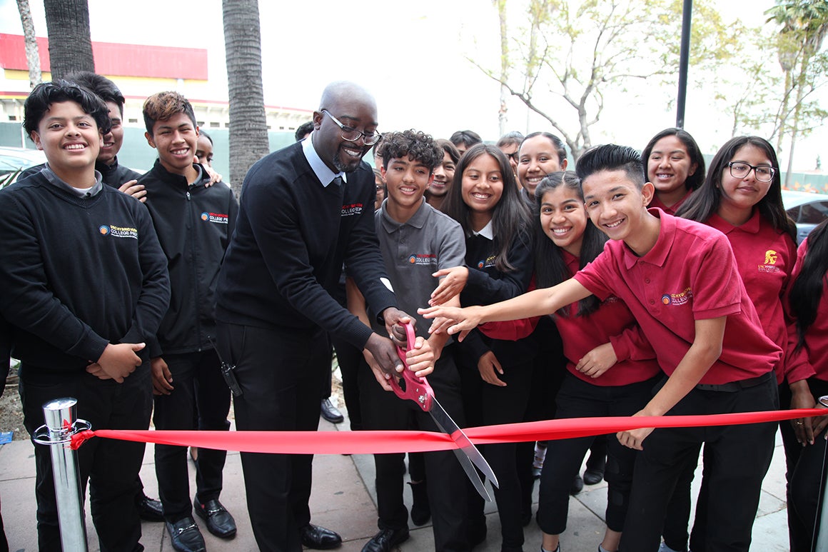 Group cutting a ribbon at an opening ceremony
