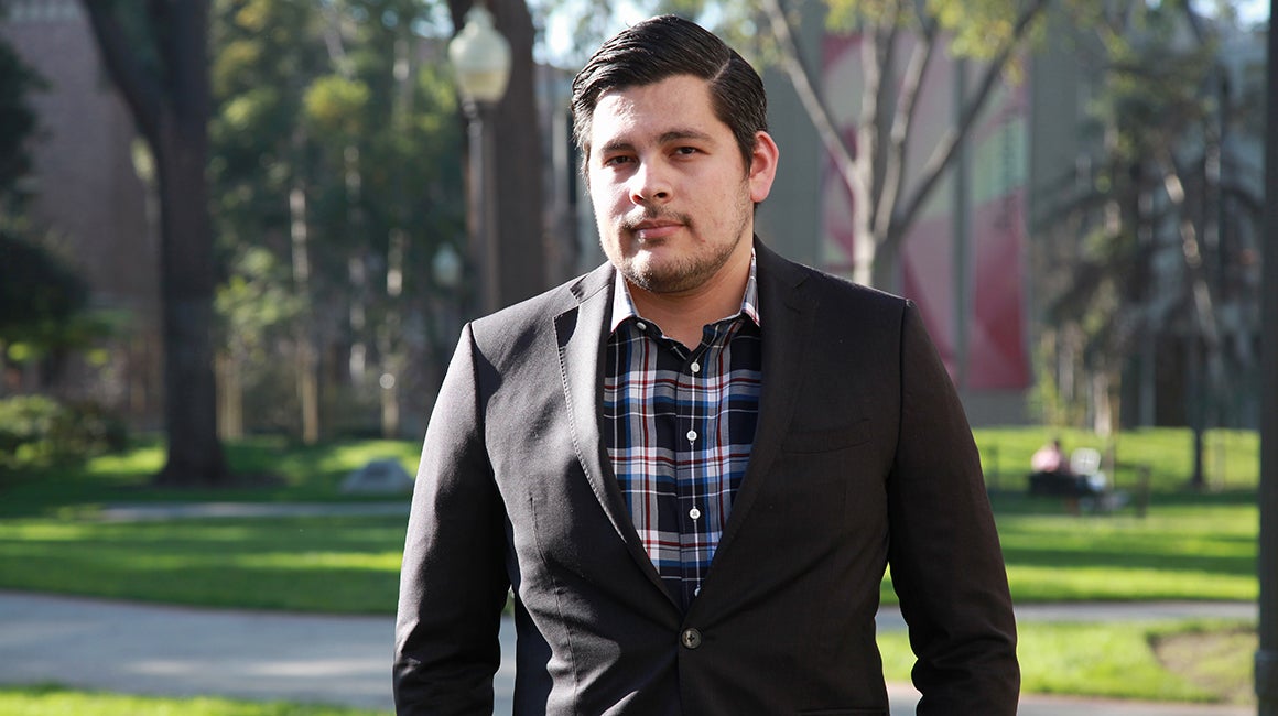 Man walking outdoors on a campus path