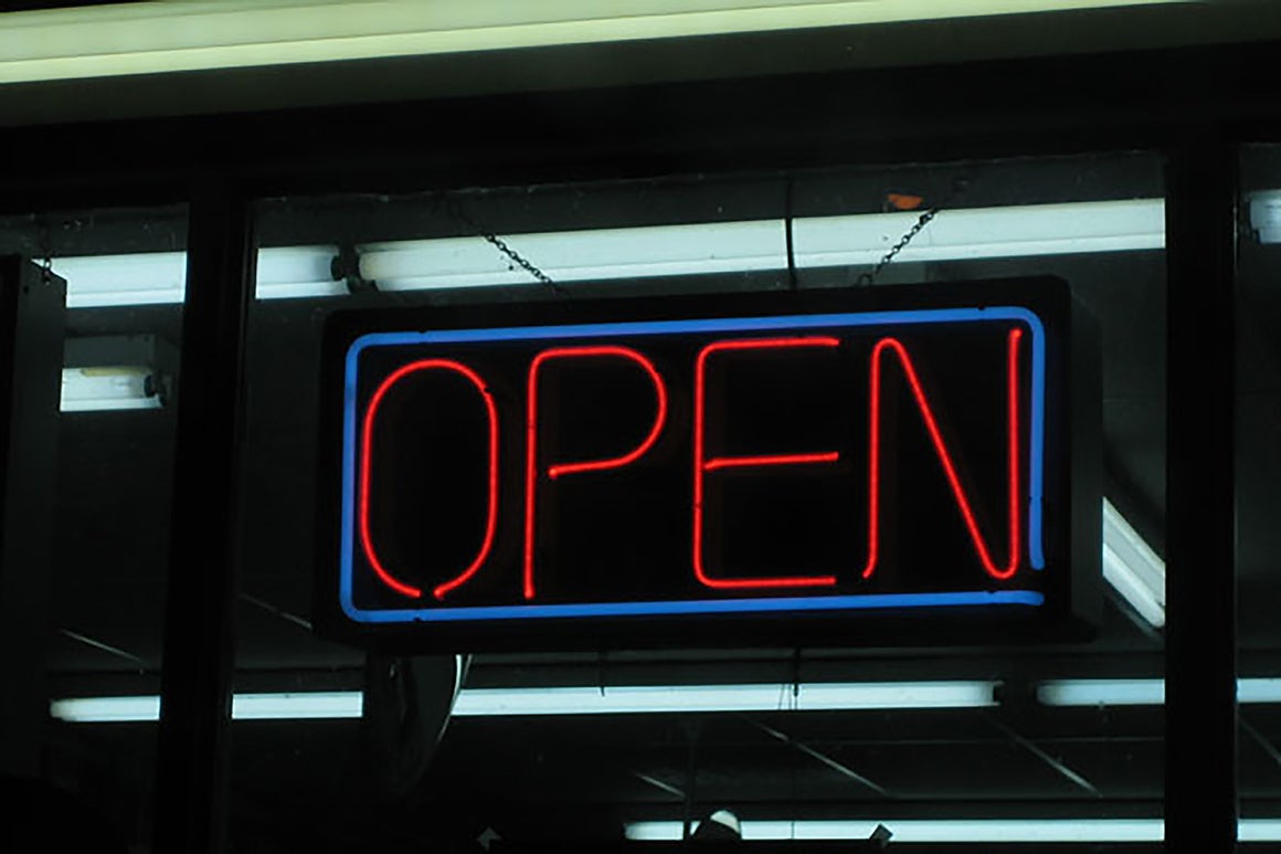 Neon "OPEN" sign displayed in a window